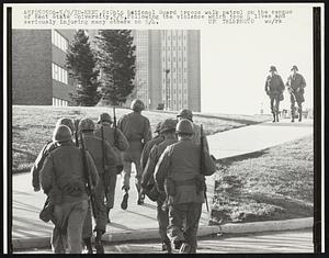 Kent, O- Ohio National Guard troops walk patrol on the campus of Kent State University, 5/5, following the violence which took 4 lives and seriously injuring many others on 5/4.