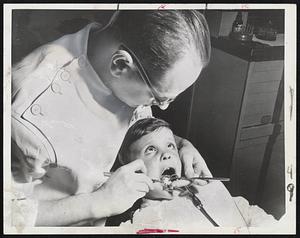 "Open Wide" -- In the future, this little boy and others may keep their mouths shut in dental offices. Vaccines or drugs may replace a myriad of dental instruments.