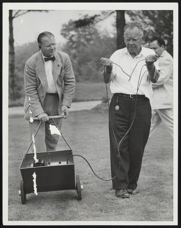 L to R. James Jenks, electro-cardiograph manufacturer, tests. Dowser Henry Gross for muscle movement and heart beat. Rear- Cherney Berg, photographers for American Society for Psychical Research.