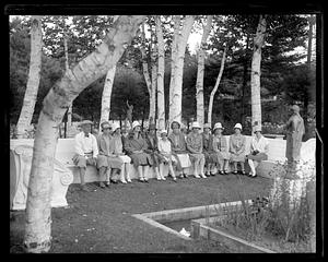 A group of people sitting in Augustus Saint-Gaudens' garden at his summer residence, "Aspet", Cornish, New Hampshire