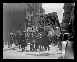 A man destroying a protest sign against fascism