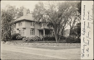 View of a house with blooming plants, taken from across the street