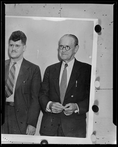 Man with glasses next to another man