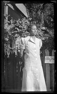 Lottie Miller stands in front of a fence