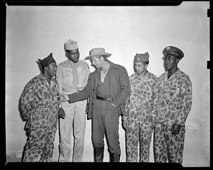 Three men in "Jungleers" uniform pose with a man in military uniform and a man in a cowboy hat