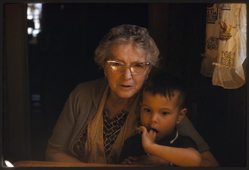 Boy sitting on older woman's lap