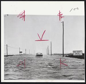 One Car makes its way through water on the Montauk Highway in Amagansett, near Montauk on the eastern tip of Long Island. Area was hard-hit by Hurricane Esther as it passed on way to New England.