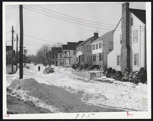 Unplowed streets and parked cars present threat to residents in event of fire. Hundreds of side streets like Rangeley St., Dorchester, in the suburbs, are unplowed.