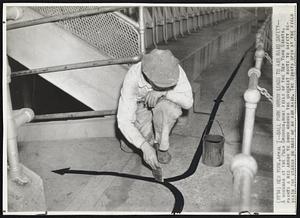Ball Park Arrow Leads to Air Raid Safety--A workman at the Polo Grounds,home field of the New York Giants, paints a red arrow to show crowds the quickest route to safety beneath the stands in case of an air raid. The Giants open at the field