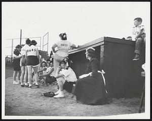 Snobs plan strategy outside dugout- Women at right is maid for the team. The Snobs do not have a trainer