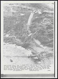 Outing, Minn. – Where Five Died – Rescue workers comb water in front of Bethany Fellowship camp near Outing, Minn. Thursday looking for more victims of Wednesday night’s tornado that ripped though the north central Minnesota community. Emergency vehicles line top of the hill where stripped and broken trees cover slope and blocks the road.