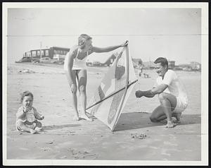 Go Fly a Kite-Donald Smith, Harvard law student, and Mrs. Smith, at Point of Pines, Revere, with their daughter, Alison, 11 months.