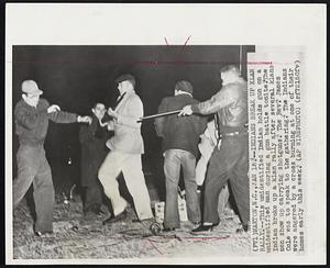 Indians Break Up Klan Rally.--This unidentified Indian holds gun on a unidentified man during a gun battle tonite. The Indian broke up a klan rally after several klansmen show up carrying shotguns. The Rev. James Cole was to speak to the gathering. The Indians were angered by a cross burning at one of their homes early this week.