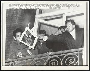 London: Militant Pakistani students wave a burning portrait of the new leader of their nation, Gen. Yahya Khan, after they invaded a building belonging to Pakistan’s High Commission here 3/25. President Ayub Khan of Pakistan resigned 3/25 and turned over power to Gen. Yahya Khan.