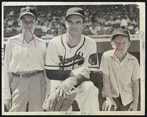 Johnny Sain and two Arlington fans pose for a photo and, judging by their caps, the boys definitely are baseball fans. Flanking the Braves pitcher are Billy Thompson (left) and Tommy Brennan.