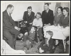 Miners Hear President's Appeal - This scene, in the home of Frank Rubnik in Library, Pa., during President Roosevelt's radio address last night, was typical of others throughout the coal fields and nation as the crisis in the coal strike was broken. Rubnik and his family and three other mine workers, listen intently as the President speaks.