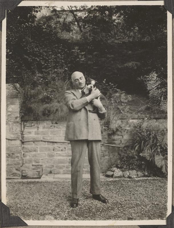 Unidentified man holding a Boston terrier