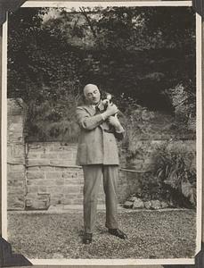 Unidentified man holding a Boston terrier