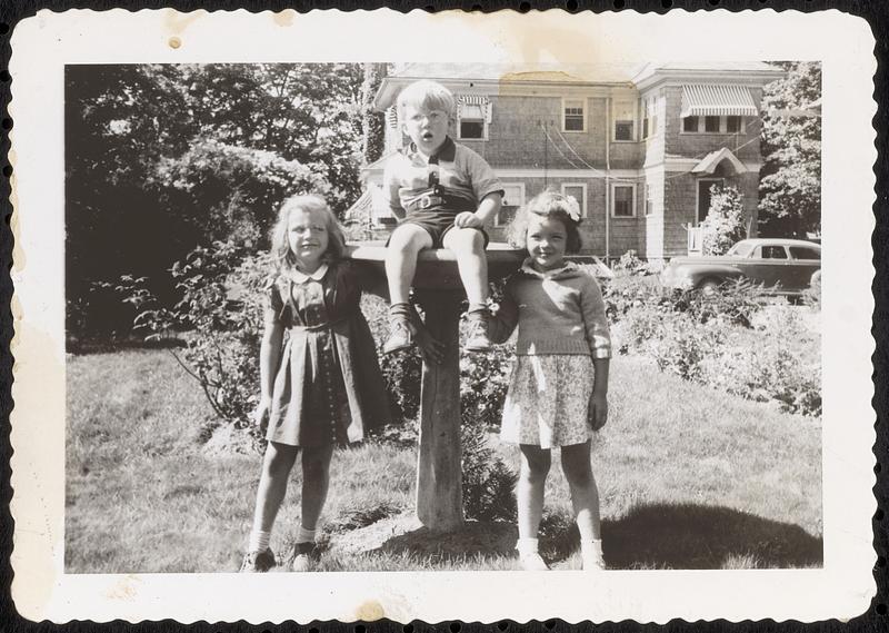 Children gathered around a birdbath in the backyard of 27 Pleasant Street