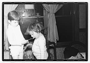 A boy feeding a girl