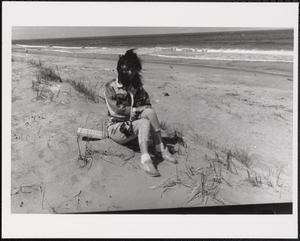 Young woman on the beach on a chilly day