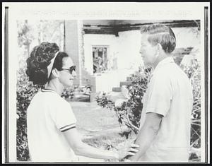 Biloxi, Miss. Mrs. C. C. Murphy is overcome with tears as she tells neighbor Nick Creel, "we lost everything!" The Murphy's hurricane damaged home is in the background