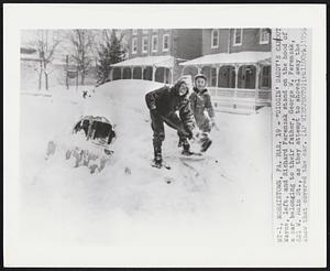 Norristown, Pa. - "Diggin' Daddy's Car Out Wayne, left, and Richard Ferenzak stand on the hood of a car belonging to their father, George W. Ferenzak, 621 W. Main St., as they attempt to shovel away the snow that covered the car.
