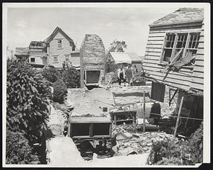 Re-Building Possibilities Are Surveyed by Mrs. Charlotte Stott, and her sister, Mrs. Rose Taylor, at wrecked remains of home at 8 Brandon Rd., Worcester.