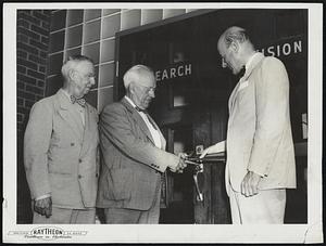 Mayor Henry A. Turner of Waltham, cuts ribbon at entrance to new plant on Seyon Street where a major portion of Raytheon’s $2,000,000 transistor development program will be carried on. Looking on are (left) Earl Arnold, secretary of the Waltham Chamber of Commerce, and (right) C.F. Adams, Jr., president of Raytheon.