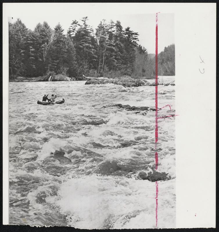 Going Down-and Under- Two students from Windham College start to swamp as they race their canoe through the Hartland, Vt., Rapids of the Connecticiut River.