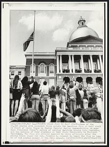 Students Order Flag to Half Staff-- Some of the 20,000 youths with clenched fists salute the American flag at half staff in front of State House in Boston Tuesday during demonstration to protest President Nixon's policy of sending American troops into Cambodia, and the killing of four students at Kent State University by National Guardsmen. The flag was ordered lowered by State officials after the youths began chant for Gov. Francis W. Sargent to lower the flag in honor of the youths killed at the Ohio school.
