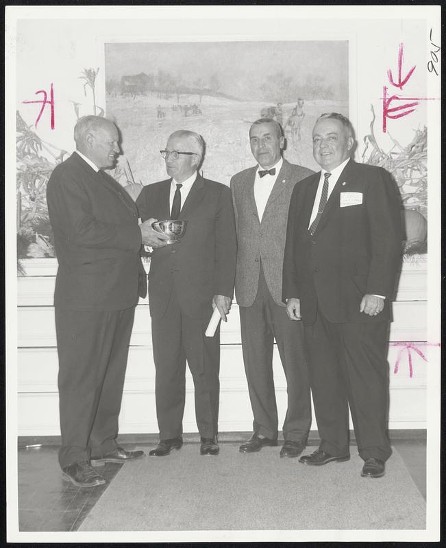 Honor Where Due - Otto Eugen Schniebs (second left), 72-yer-old Bavarian-born gadfather of New England skiing and first Darthmouth coach, receives the New England Council's annual silver bowl award for outstanding contribution to the sport from, left to right, Bill Whitney of Black Mountain, Bill Norton, Cannon Mountain, and Gen. John O'Brien of the New England Council at the 18th annual winter sports conference.