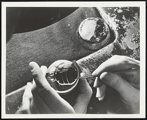 The near-distance segments of trifocal lenses are accurately placed before fusing and grinding operations at the American Optical lens plant in Southbridge.