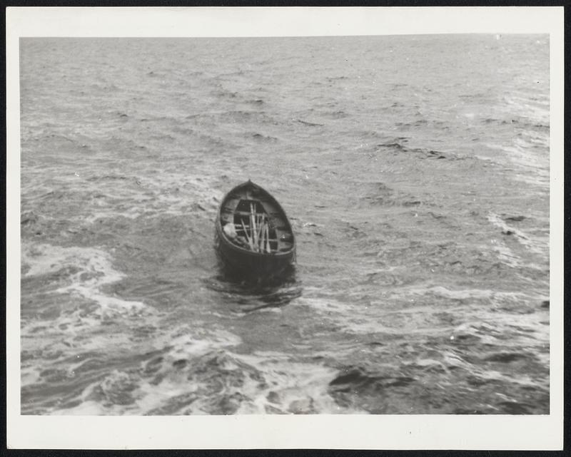 An Untold Story of the Sea At Sea-This empty lifeboat, a plaything of the elements, apparently tells a story of tragedy at sea, a story that only the sea can tell. The tiny craft, rising and falling on the never-ceasing ebb and flow of the waters, was pictured from the American Export Liner Exeter, a day out of Lisbon as the vessel was bound for the Portugese capital.