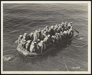 The world's largest rubber life boat, built by The Firestone Tire & Rubber Company, reaches a new peak of efficiency. Built to carry 25 men, the boat is put through further tests (above) by the U. S. Coast Guard at San Pedro, Calif., by packing 54 men aboard. Not only does the boat safely hold the men but it also is easy to handle and rides 8-foot waves with ease. When deflated the boat is 5 feet by 7 feet by 18 inches and within three minutes can be inflated to 25 feet long and 10 feet abeam. The Firestone boat is expected to be of far-reaching importance to the armed forces and to be the shipping industry.