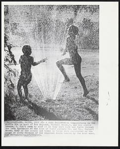 A Cool Ballet-With temperatures in the middle 90s in most of New England, Michael Brown, 5, and his sister Leanne, 9, don't seem to mind it as they dart back and forth through the lawn sprinkler at the home of their parents Mr. and Mrs. Maynard Brown. Many of the cities and towns in Maine were restricted on the usage of water because of the abnormal drain caused by the heat wave.