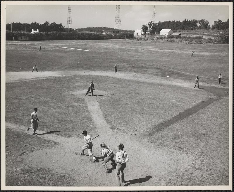 Private First Class Charles Brinkman of the marine detachment, NOB, Bermuda, comes into score when Private Burrell L. Crockett cracks a base hit