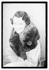 A woman with a fur scarf around her neck