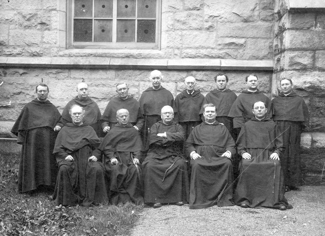 Group photo of 13 priests including Fr. O'Reilly