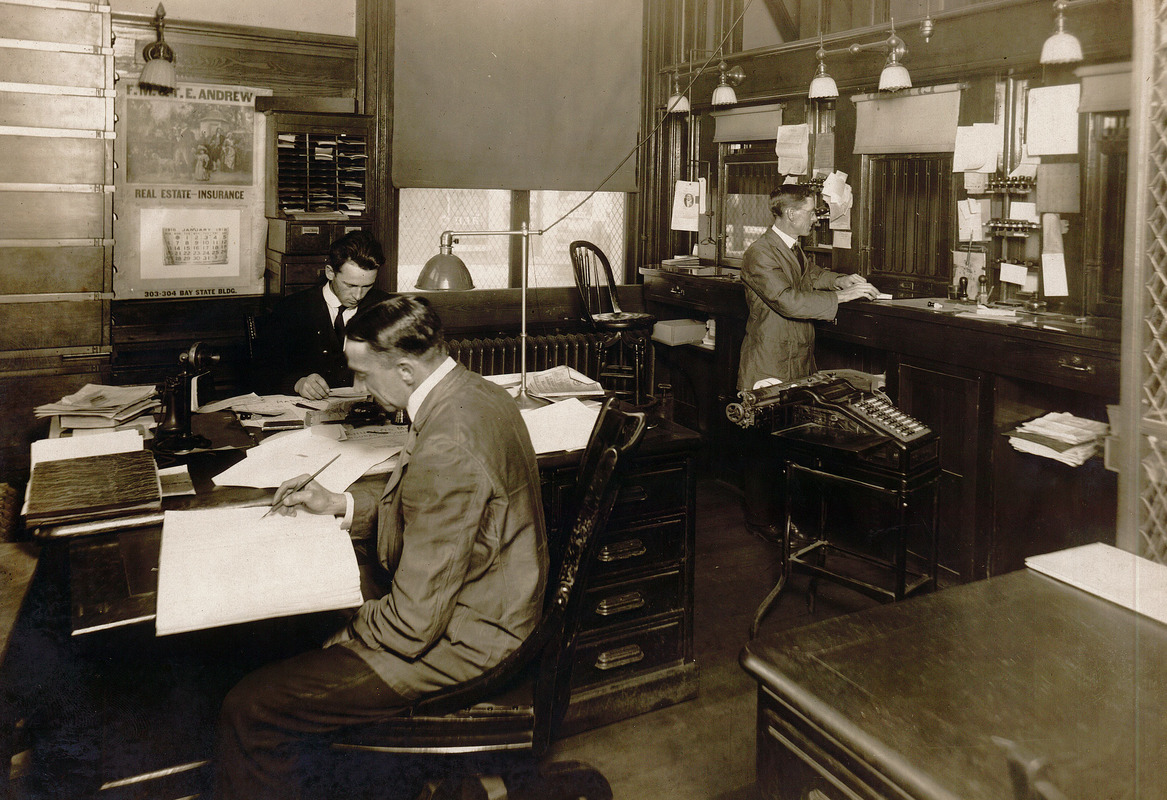 Three men working behind the windows at the Lawrence, Massachusetts Post Office