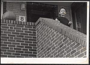 Child looking down from a staircase
