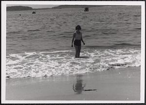 Woman standing in the surf at the beach