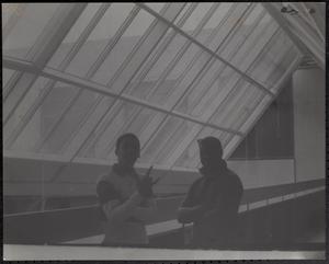 Two young men beneath a skylight