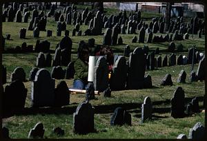 Two people taking gravestone rubbings, Granary Burying Ground, Boston