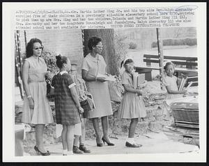 Dr. Martin Luther King Jr. and his top aide Rev. Ralph Abernathy enrolled five of their children in a previously all-white elementary school here 8/30. Arriving to pick them up are Mrs. King and her two children, Yolanda and Martin Luther King III (L). Mrs. Abernathy and her two daughters Donzaleigh and Juandalynn. Ralph Abernathy III who also attended school was not available for pictures.