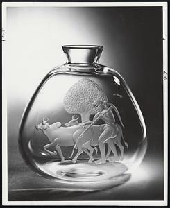 "Asian Artists in Crystal" exhibition of 18 pieces by Steuben Glass is on display through March 29 at the Shreve, Crump & Low Steuben Glass Room. Flask-shaped vase (above) shows Indian farm scene.