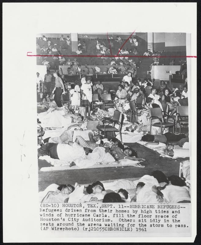 Hurricane Refugees--Refugees driven from their homes by high tides and winds of hurricane Carla, fill the floor space of Houston's City Auditorium. Others sit idly in the seats around the arena waiting for the storm to pass.