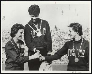 “The Grand Olympics,” a notable color documentary film of the 1960 Olympic Games in Rome will open at the West End Cinema on Thursday night with a benefit showing for the 1964 Olympics. Shown here, standing, is Wilma Rudolph, winner of several gold medals for her remarkable running.