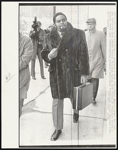 Sporting a mink coat, Johnny Sample, former New York Jet defensive back leaves Federal Building during noon recess. He testified before a federal grand jury investigating possible anti-trust violations in the National Football League.