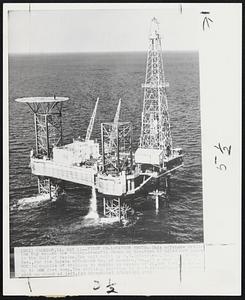 First On-Location Photo--This offshore drilling rig called the "Vinegarroon" is shown on location 12 miles off shore in the Gulf of Mexico. The unit built by R.G. LeTourneau, Inc., Longview, Tex., for the Zapata Off-Shore Co. of Houston, Tex., at a cost of $3,250,000 is capable of drilling to depths in excess of 20,000 feet, in waters up to 100 feet deep. The drilling platform is self-elevating. Note heliport on stand at left.